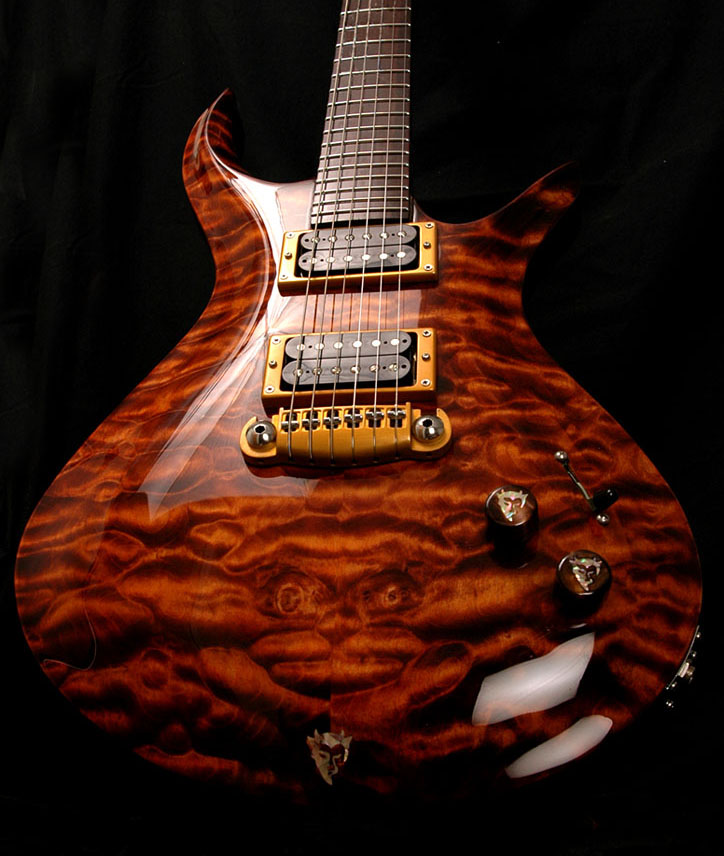Quilted maple Driskill Diablo electric guitar against a black backdrop